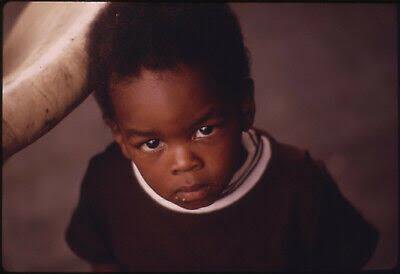 A young child in Chicago, from the DOCUMERICA project, photographed by John H. White, 1973.